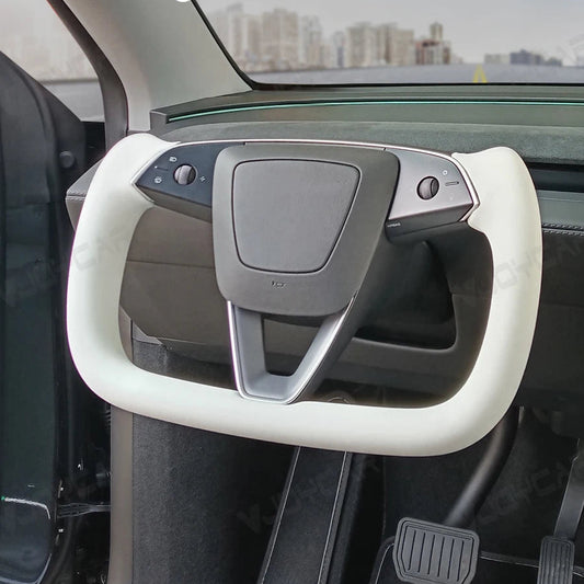 White heated yoke steering wheel for Tesla Model Y 2025 Juniper, premium leather racing style handle installed in vehicle interior.