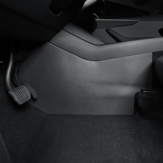Close-up of the Tesla Model Y center console kick pad installed near the driver's footwell, providing scratch and dirt protection.