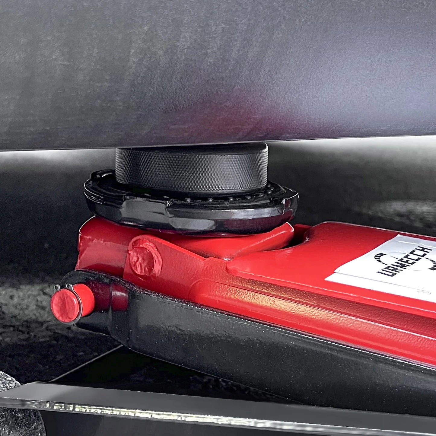 20mm rubber jack pad installed on Tesla lift point with floor jack